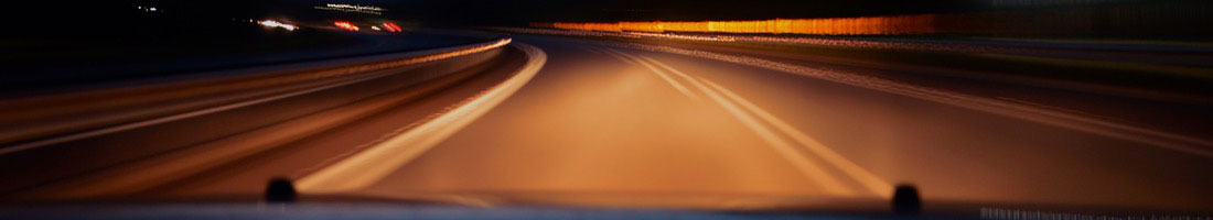 highway seen from car window at night